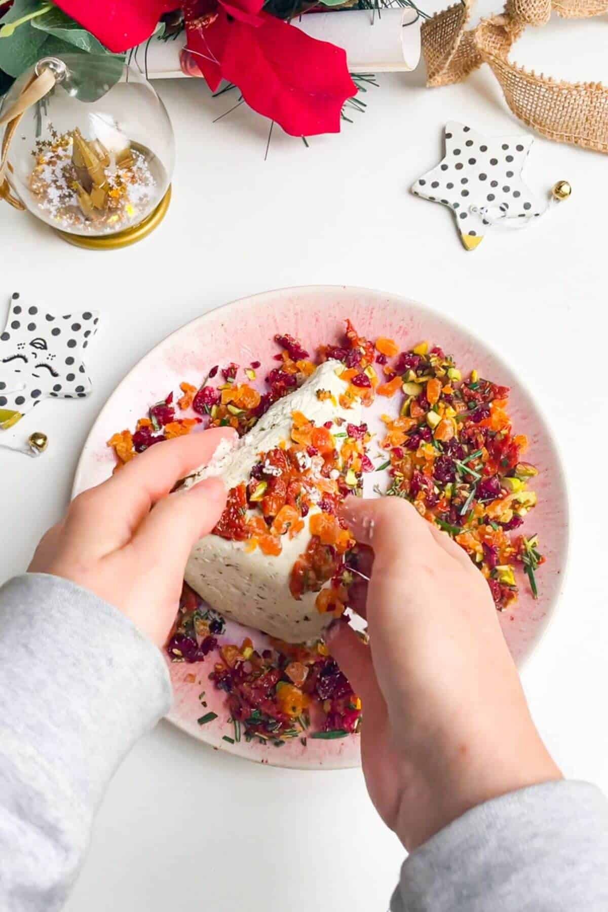 Rolling cheese tree in festive toppings.