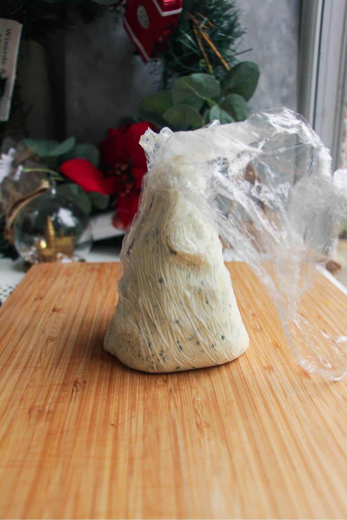 Cling film wrapped cheese cone.
