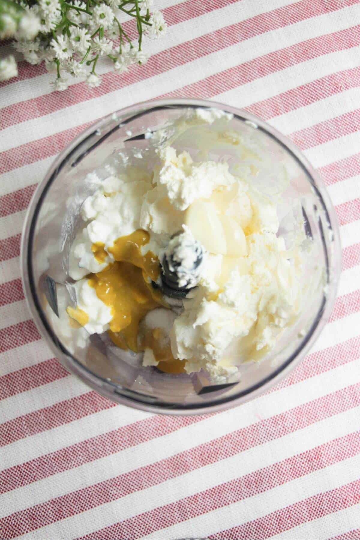 Cream cheese, cottage cheese, mustard and seasoning in a small food chopper.