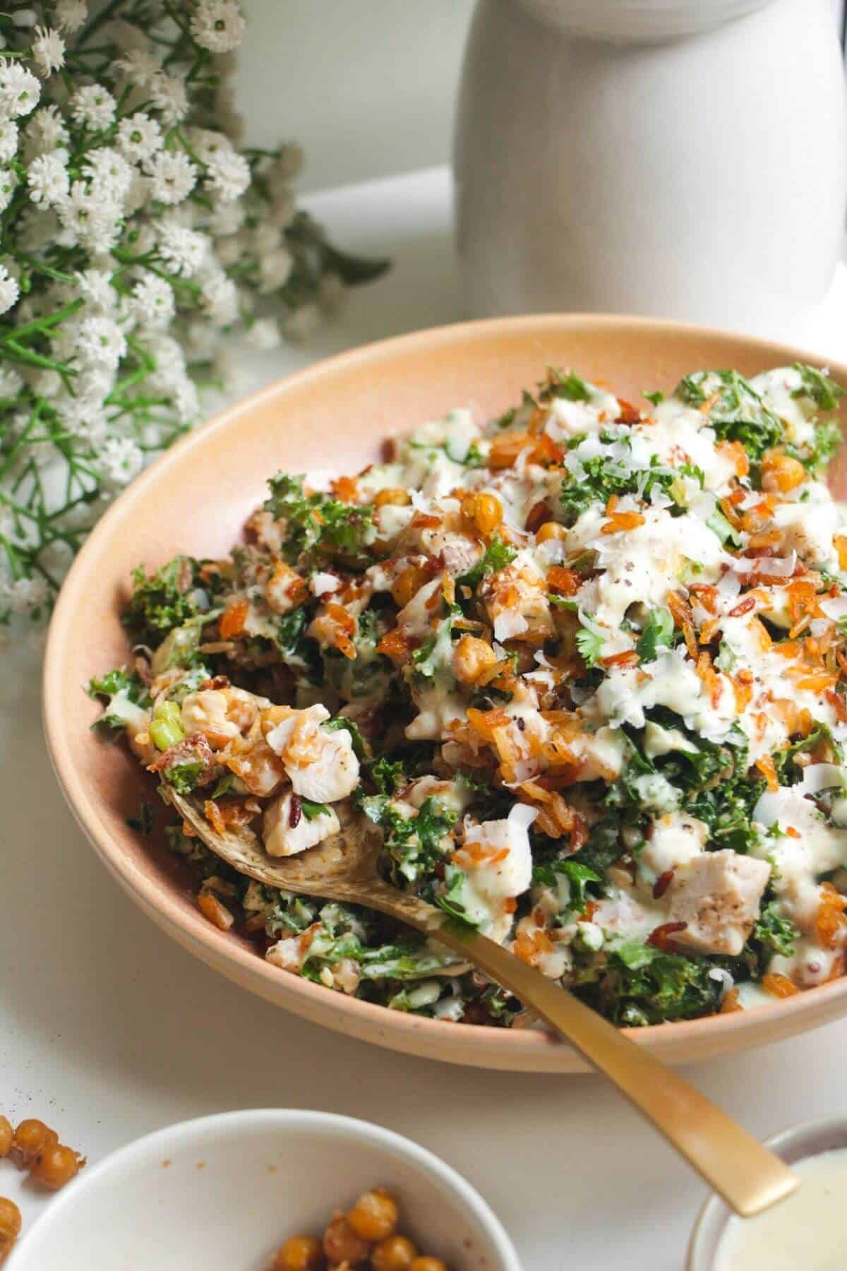 Close up of Caesar rice salad in a pink bowl.