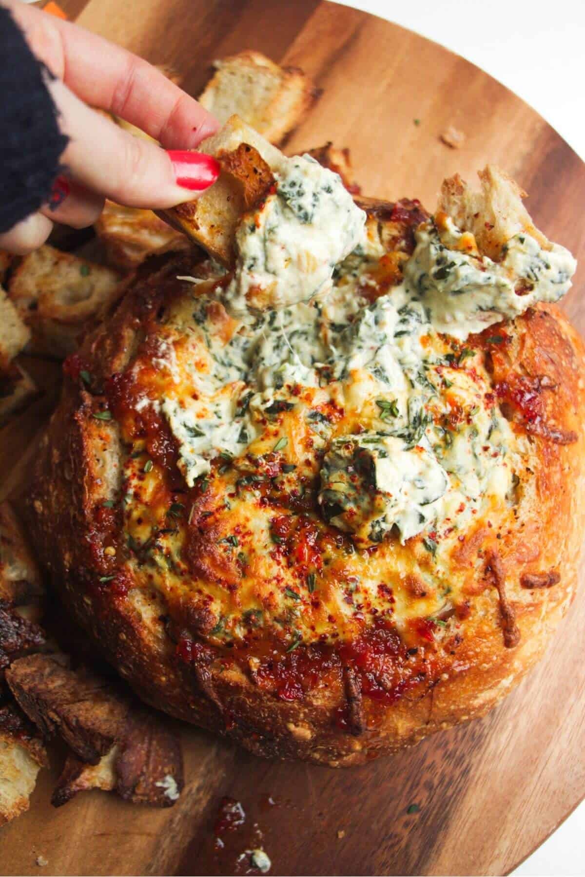 Cheesy spinach dip in a bread bowl.