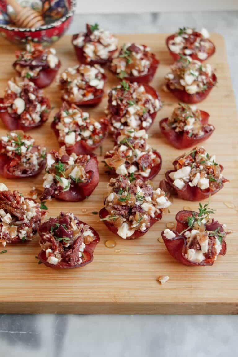 Loaded crispy salami bites on a wooden board.