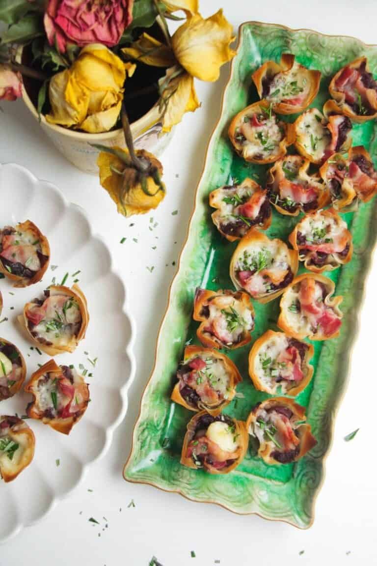 Caramelized onion filo bites on a green plate.
