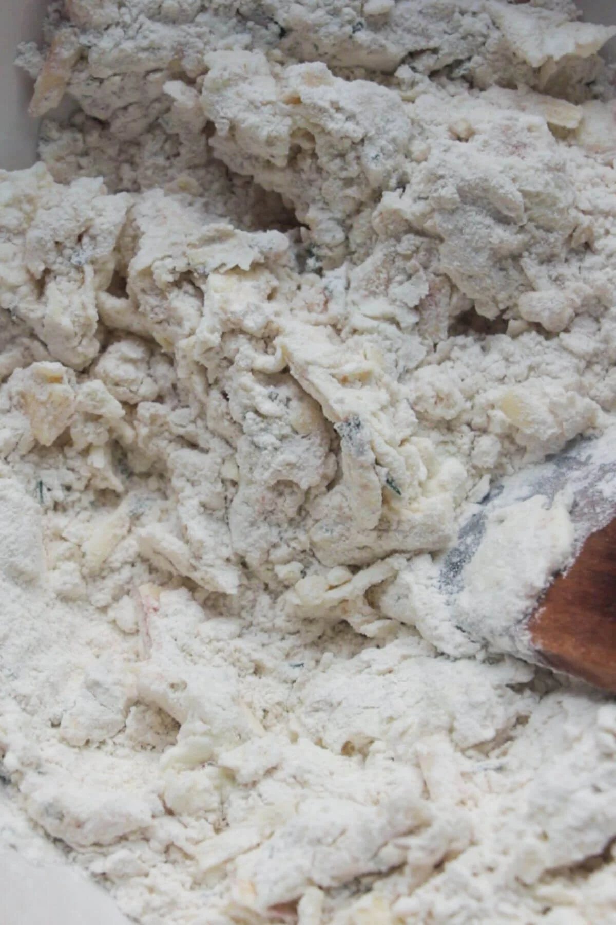 Wooden spatula mixing scone dough.