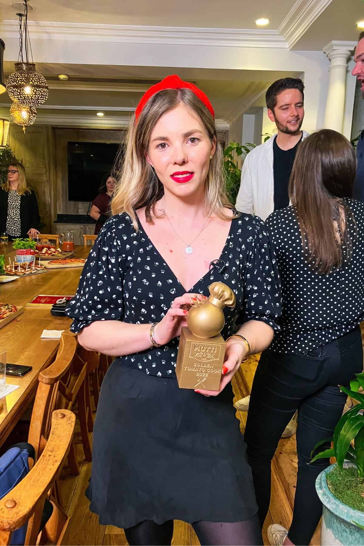 Kate holding Mutti award.