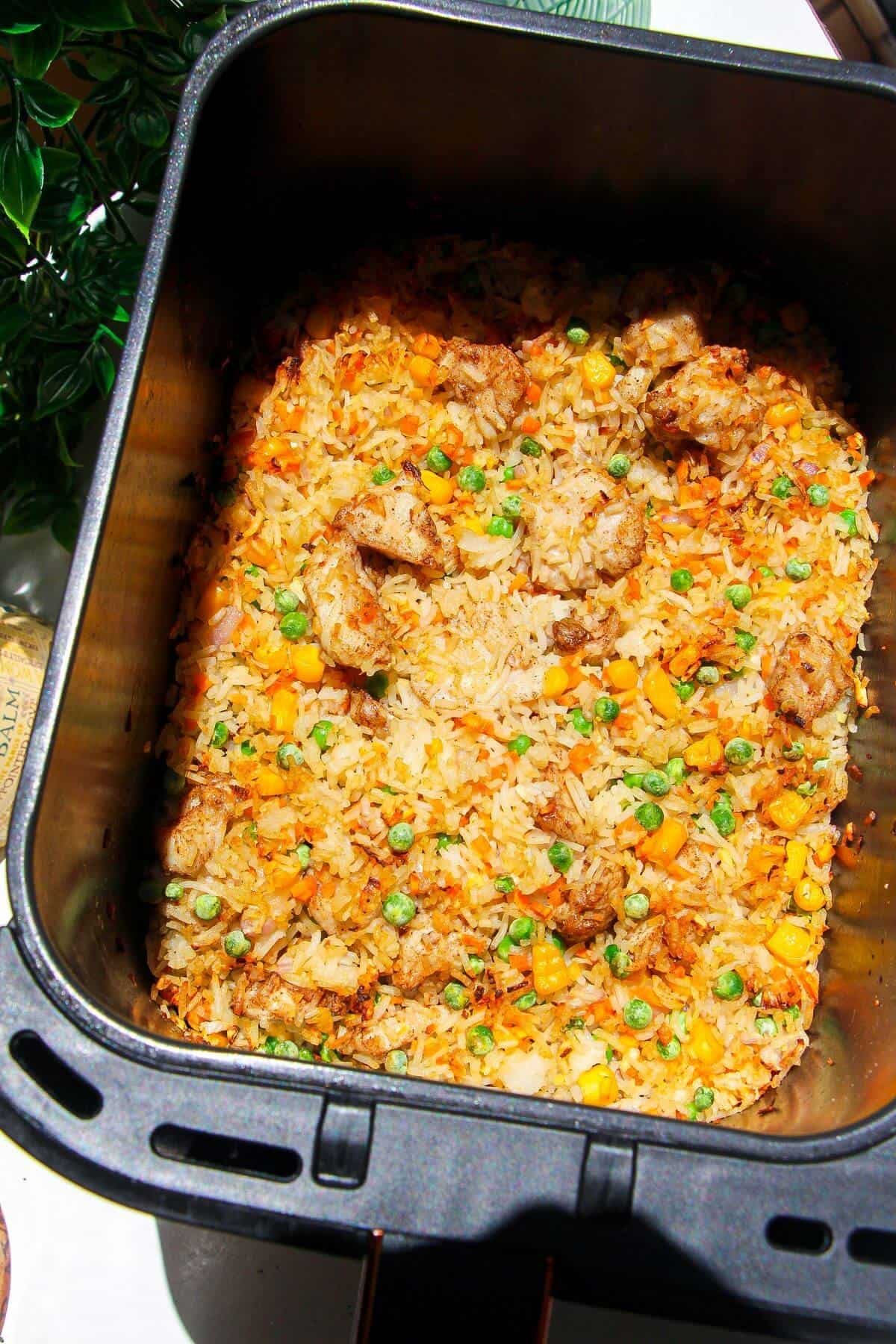 Cooked air fryer fried rice in air fryer basket.