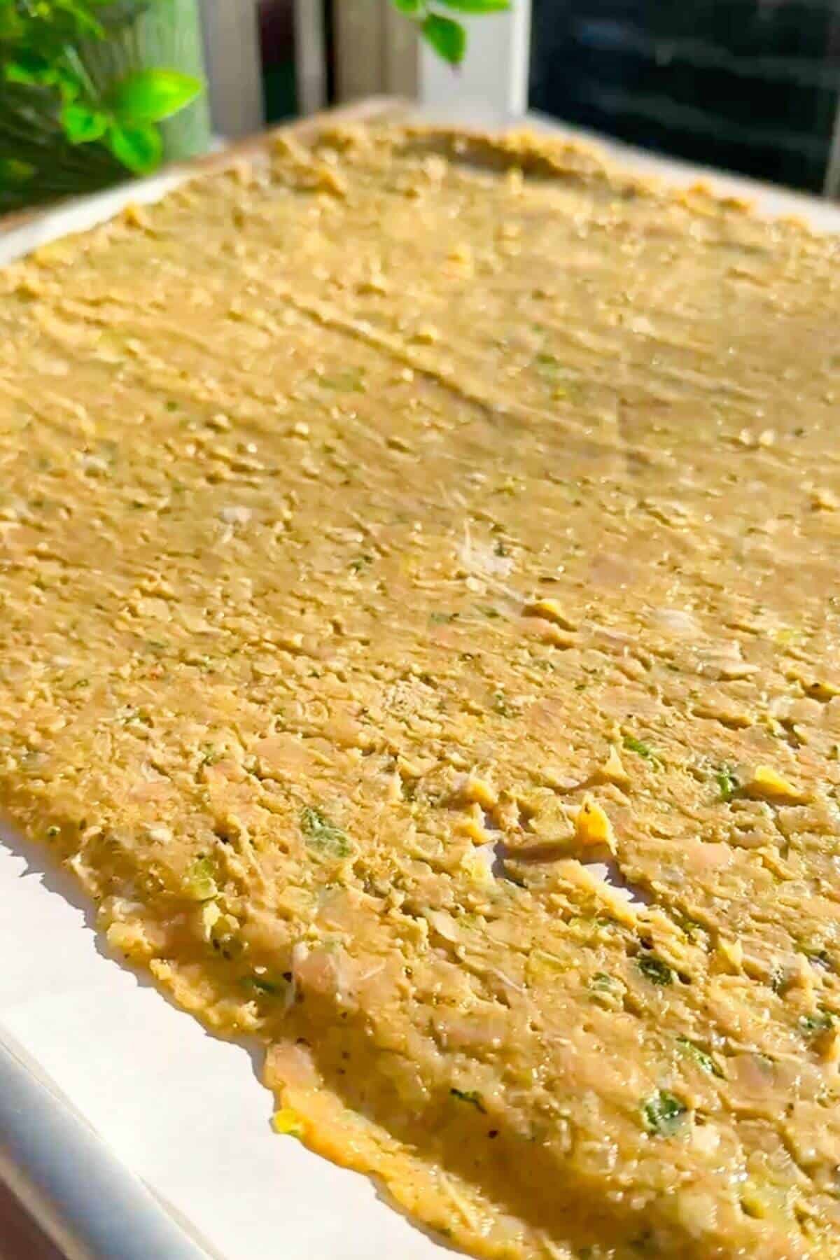Rolled out doner mixture on parchment paper.
