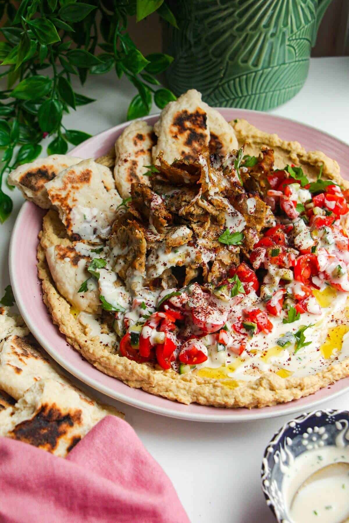 Chicken doner with salad, flatbreads and hummus.