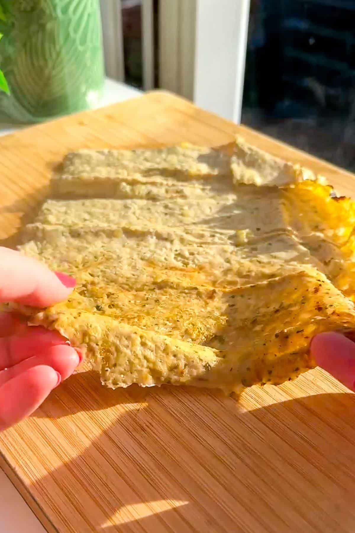 Cooked doner meat on a wooden board.