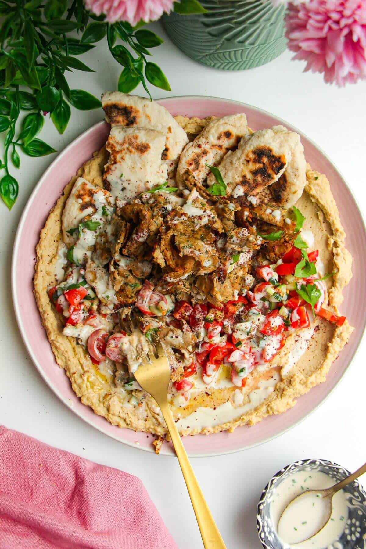 Chicken doner with salad, flatbreads and hummus.