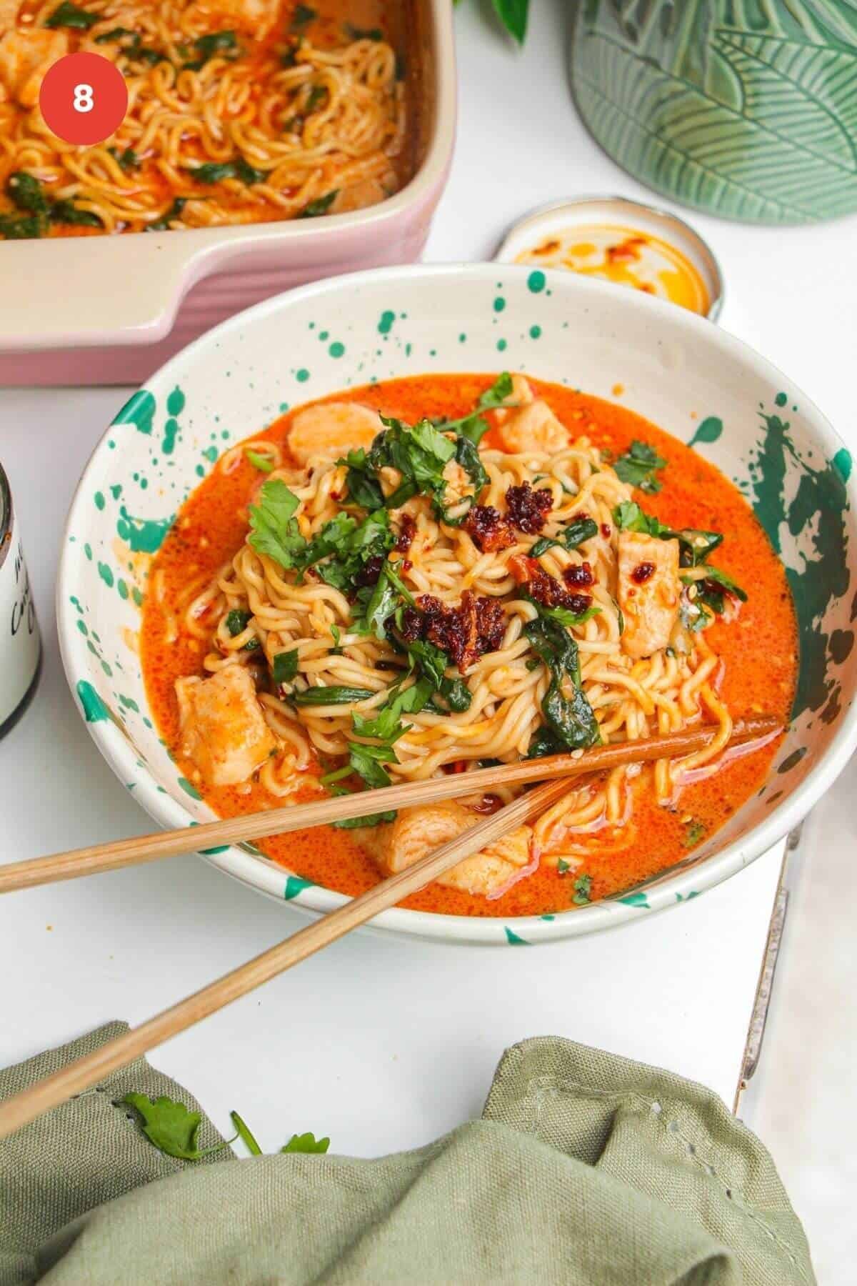 Saucy satay ramen in a bowl, with chopsticks.