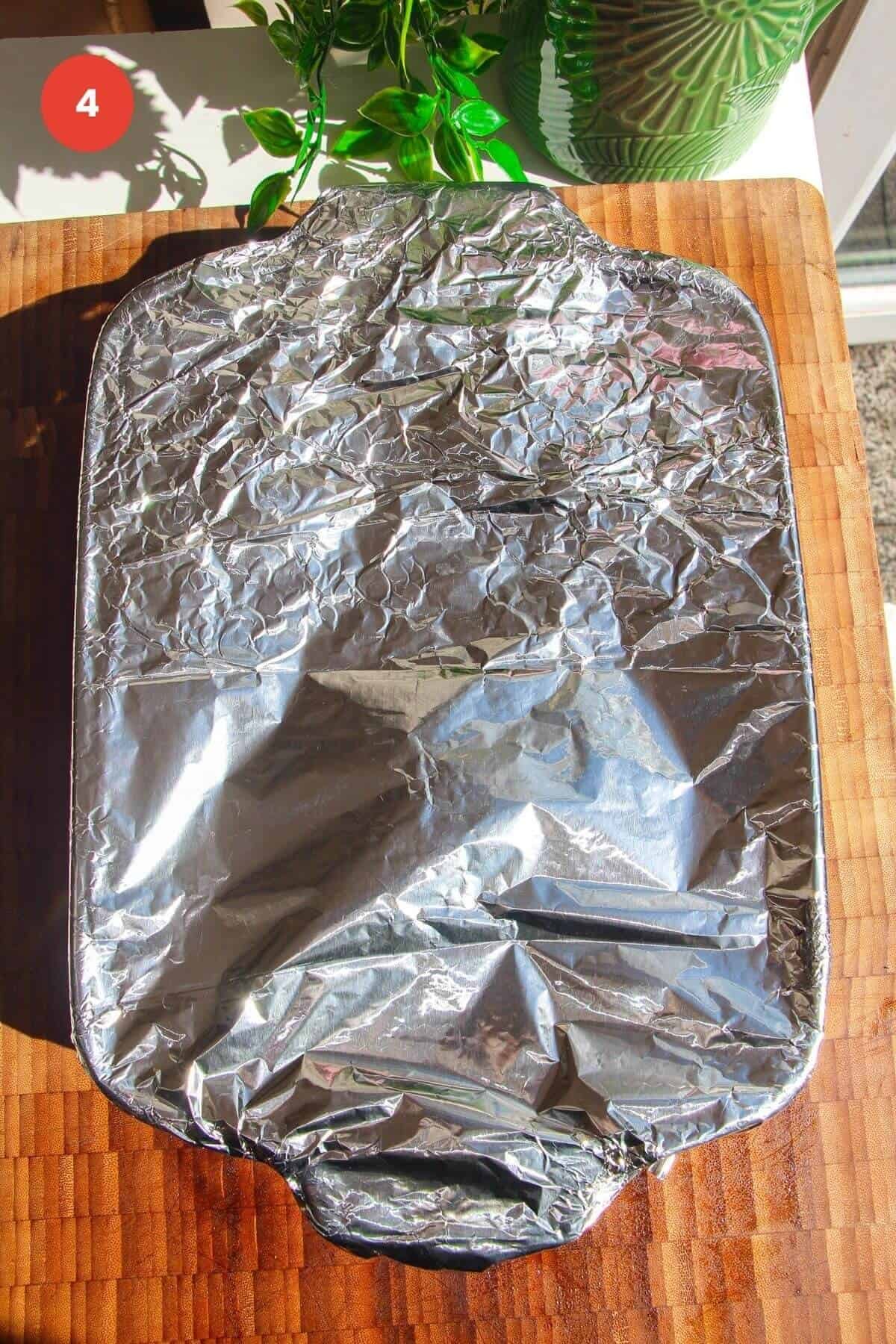 Foil tightly wrapped around an oven dish.