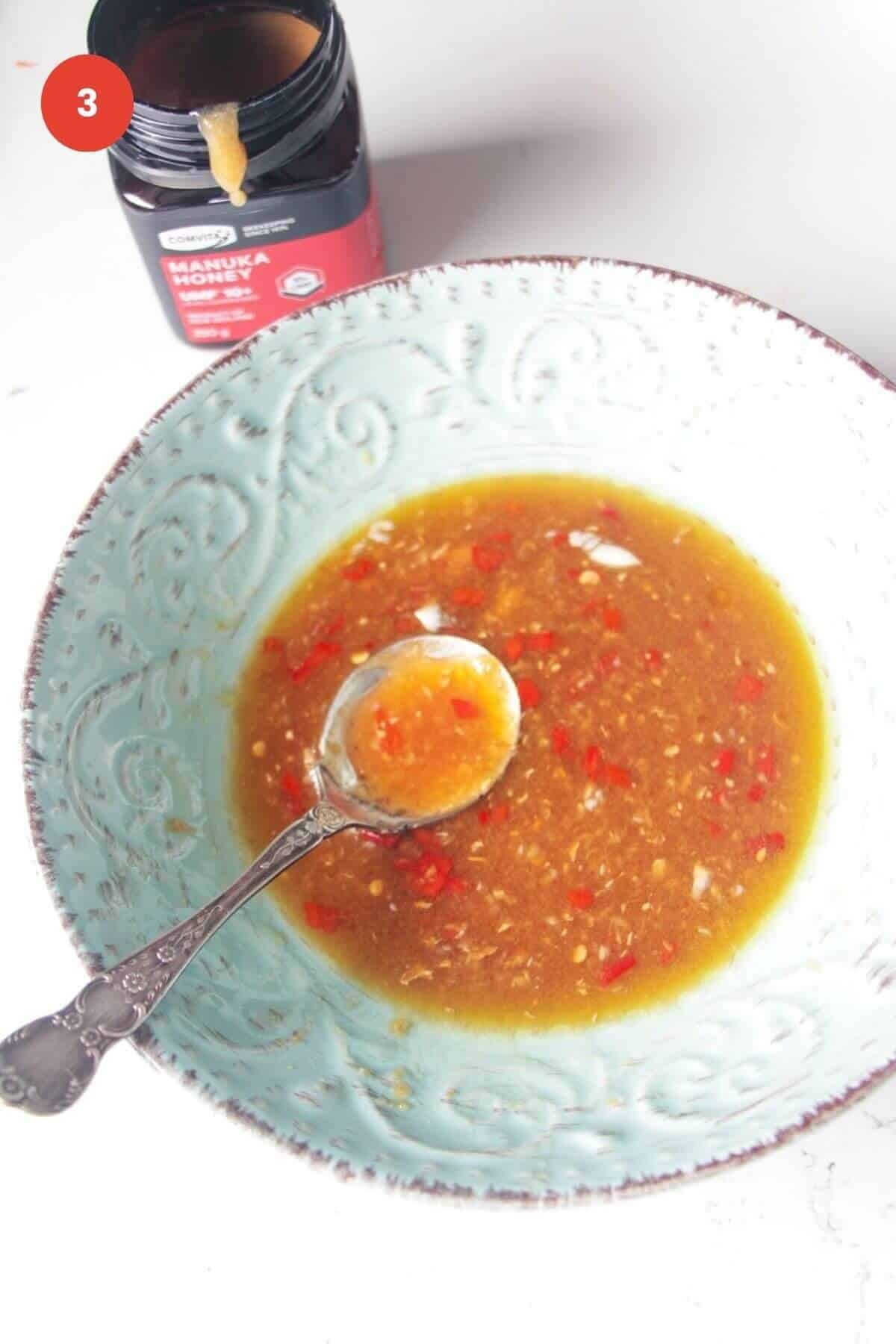 Spoon in a bowl with honey miso dressing.