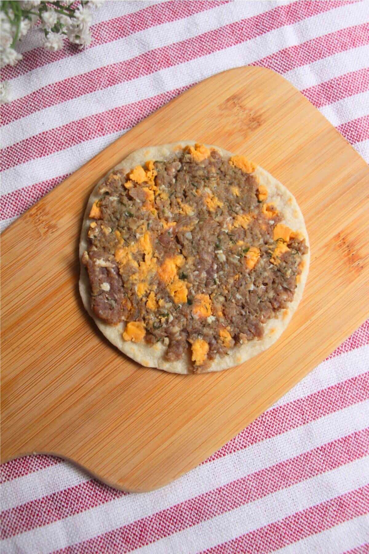 Cheeseburger topping on taco.