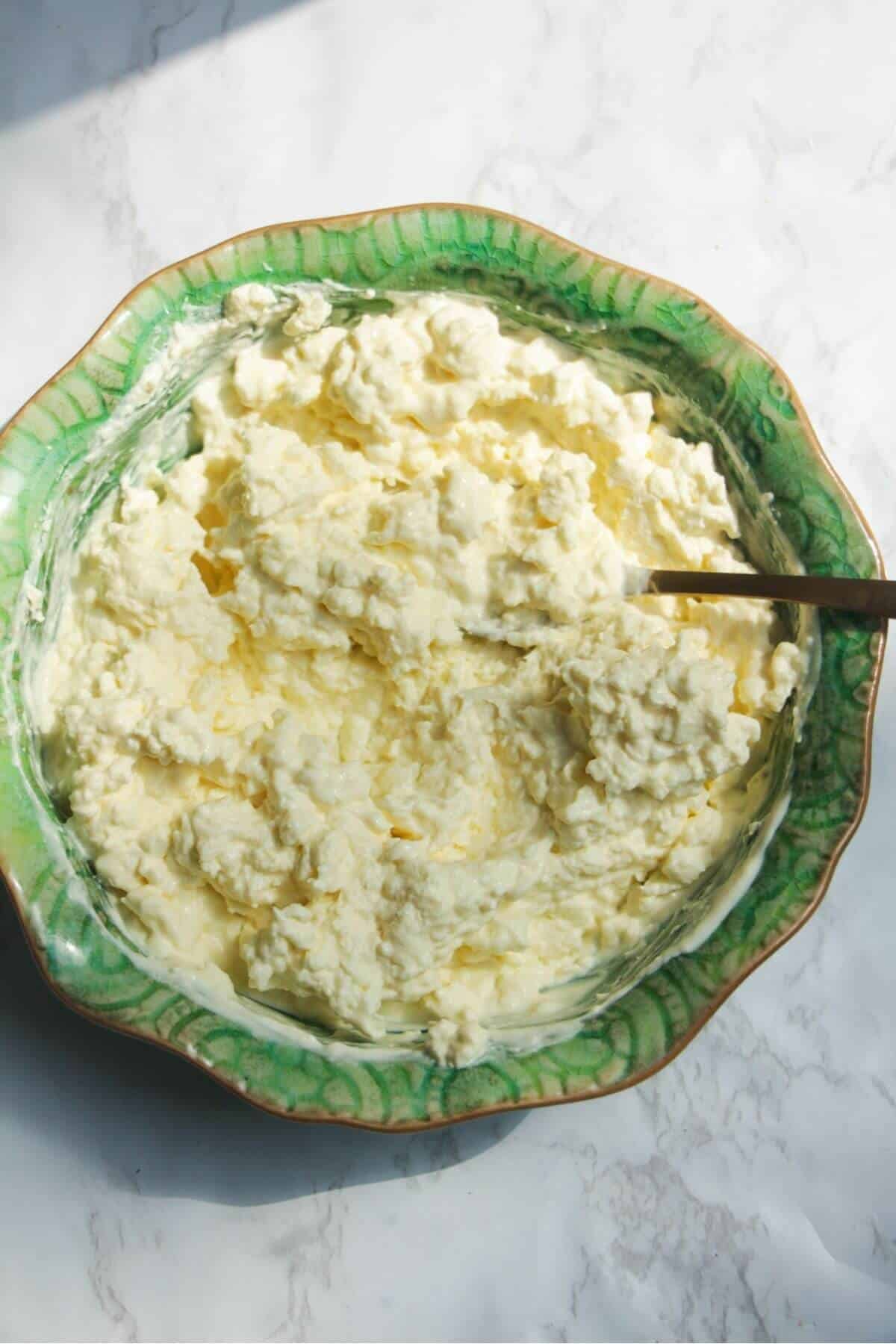 Soaked and thickened cheat's mozzarella in a small green bowl.