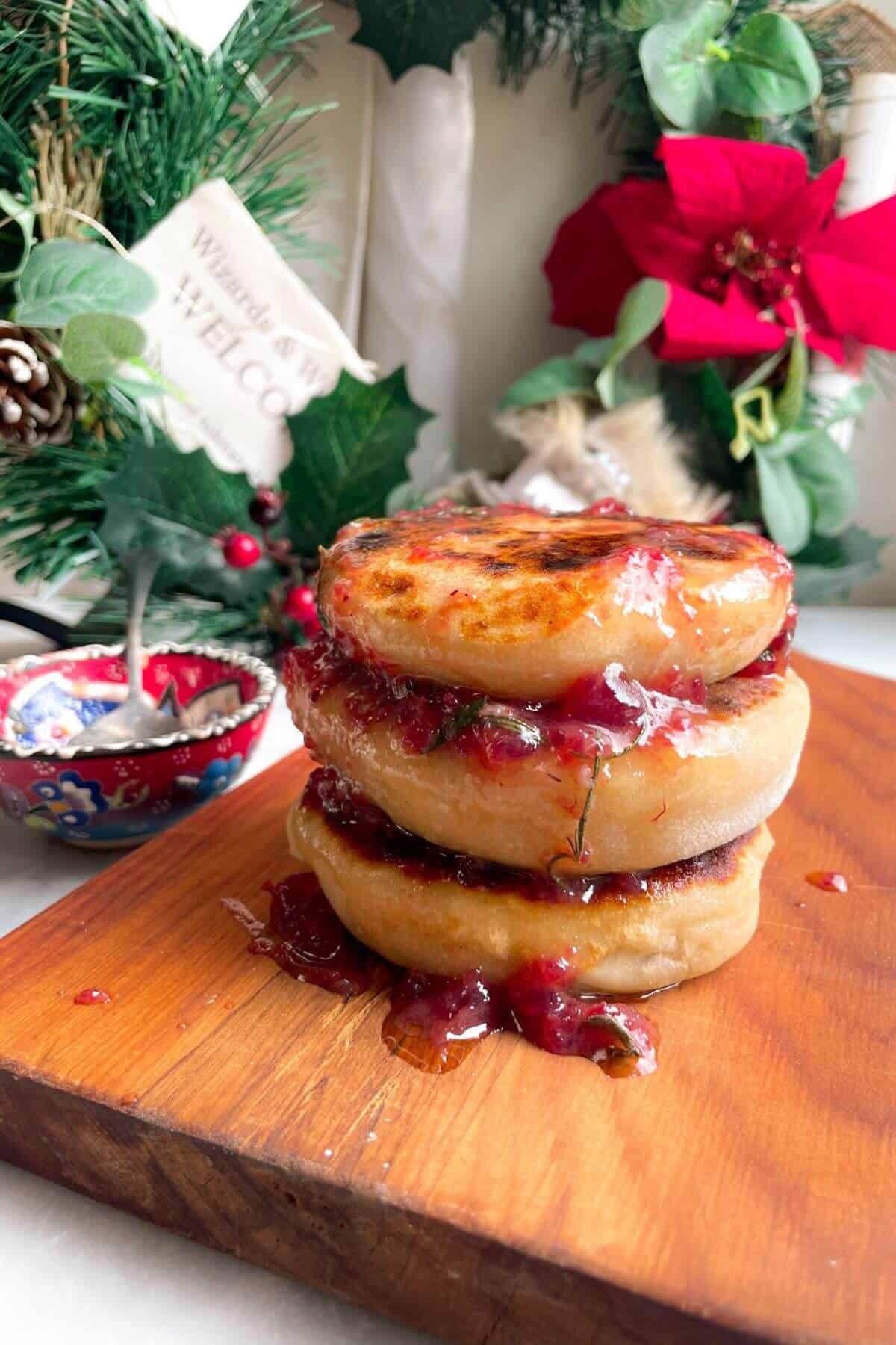 Stack of brie stuffed flatbreads drizzled with cranberry butter.