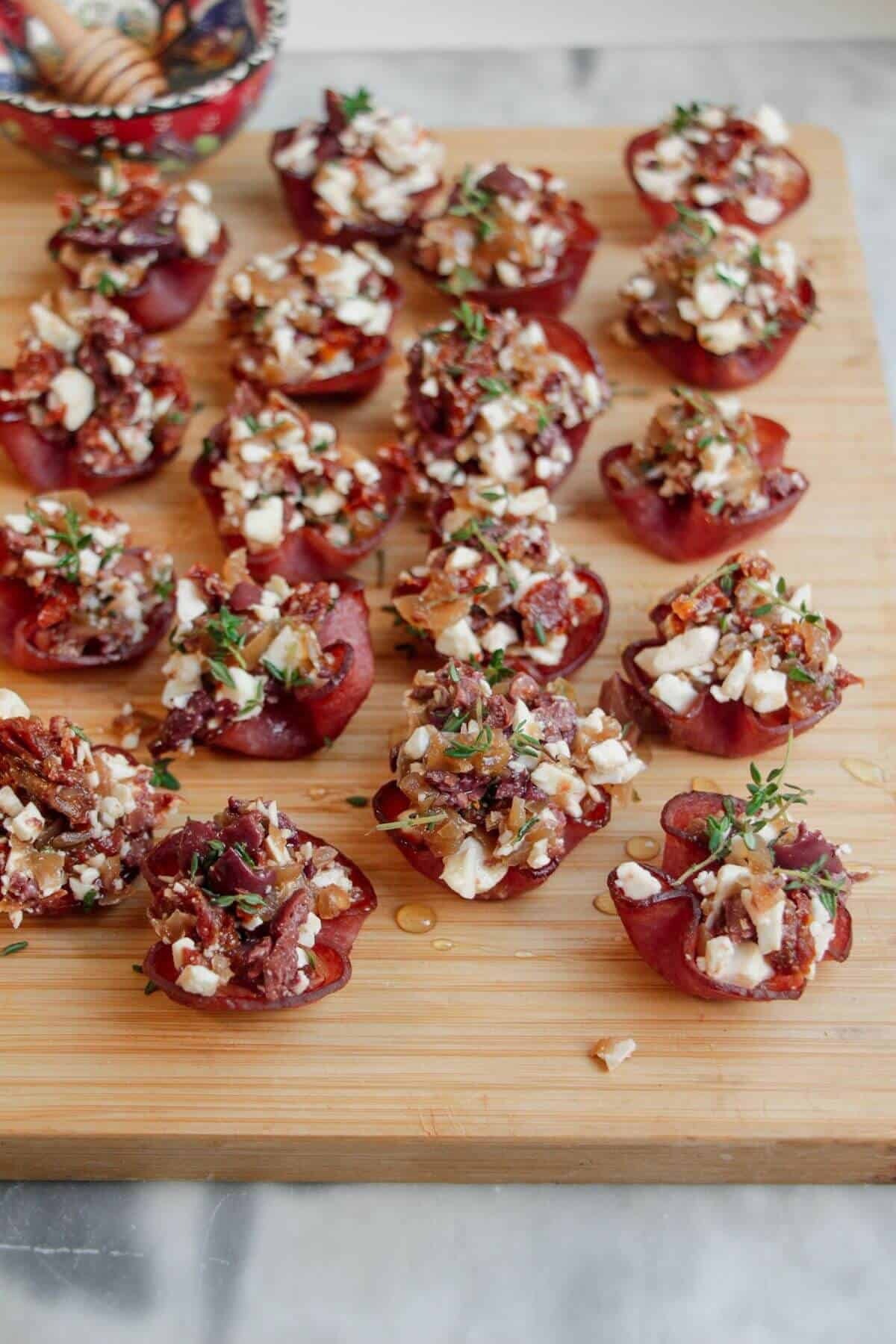 Loaded crispy salami bites on a wooden board.