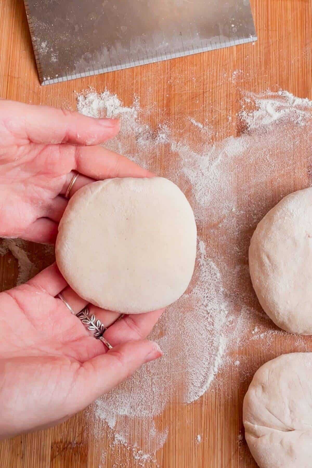 Hands holding up brie and cranberry stuffed flatbread.