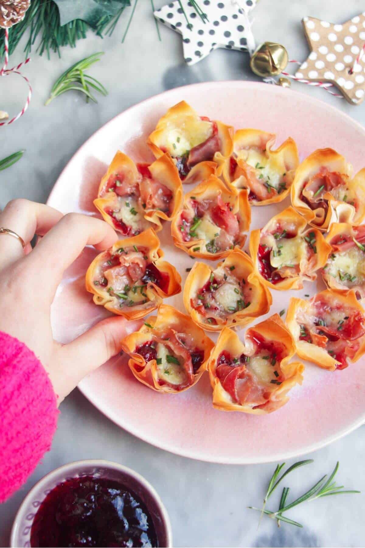 Brie filo bites on a small pink plate.