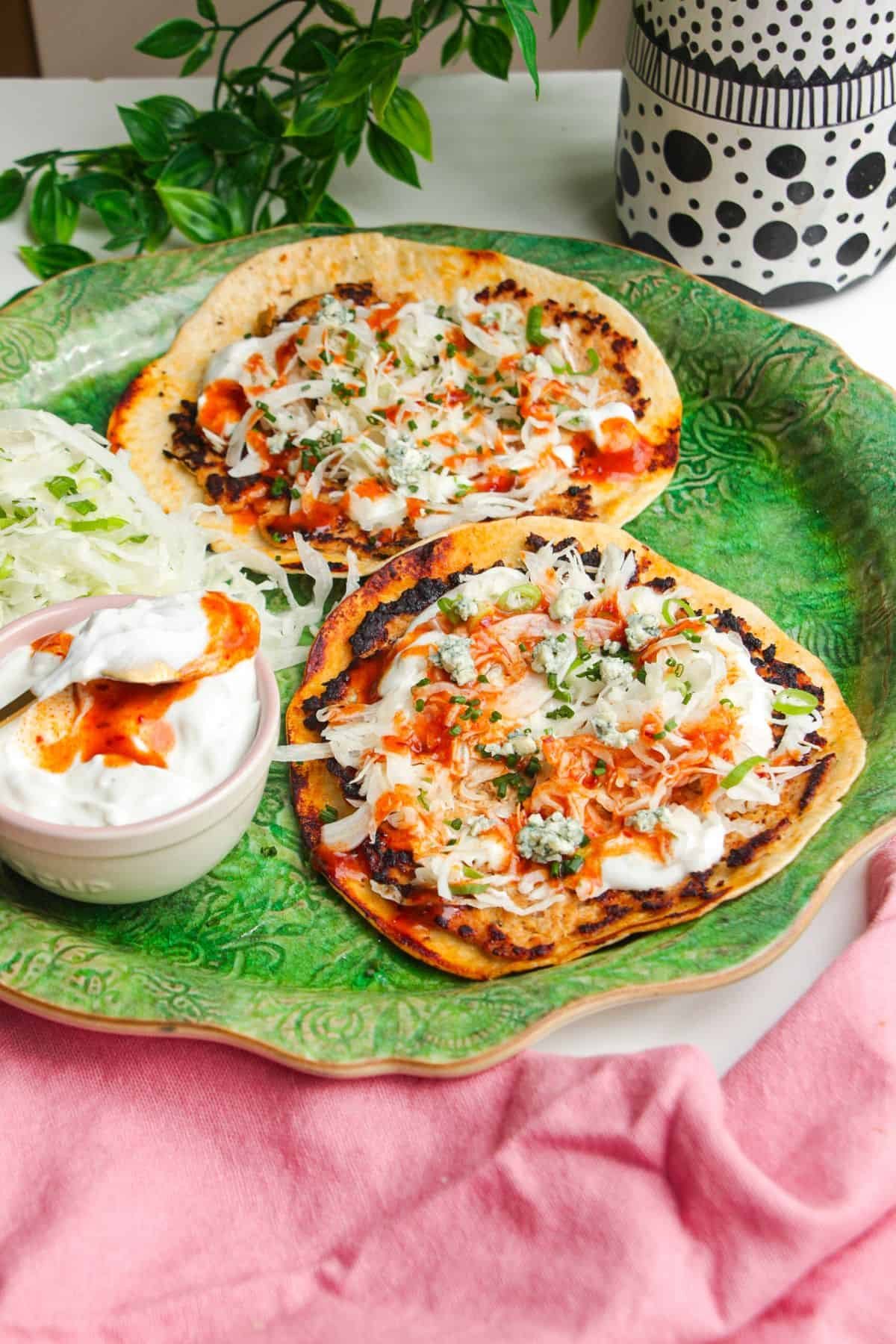 Buffalo chicken smash tacos on a serving platter.