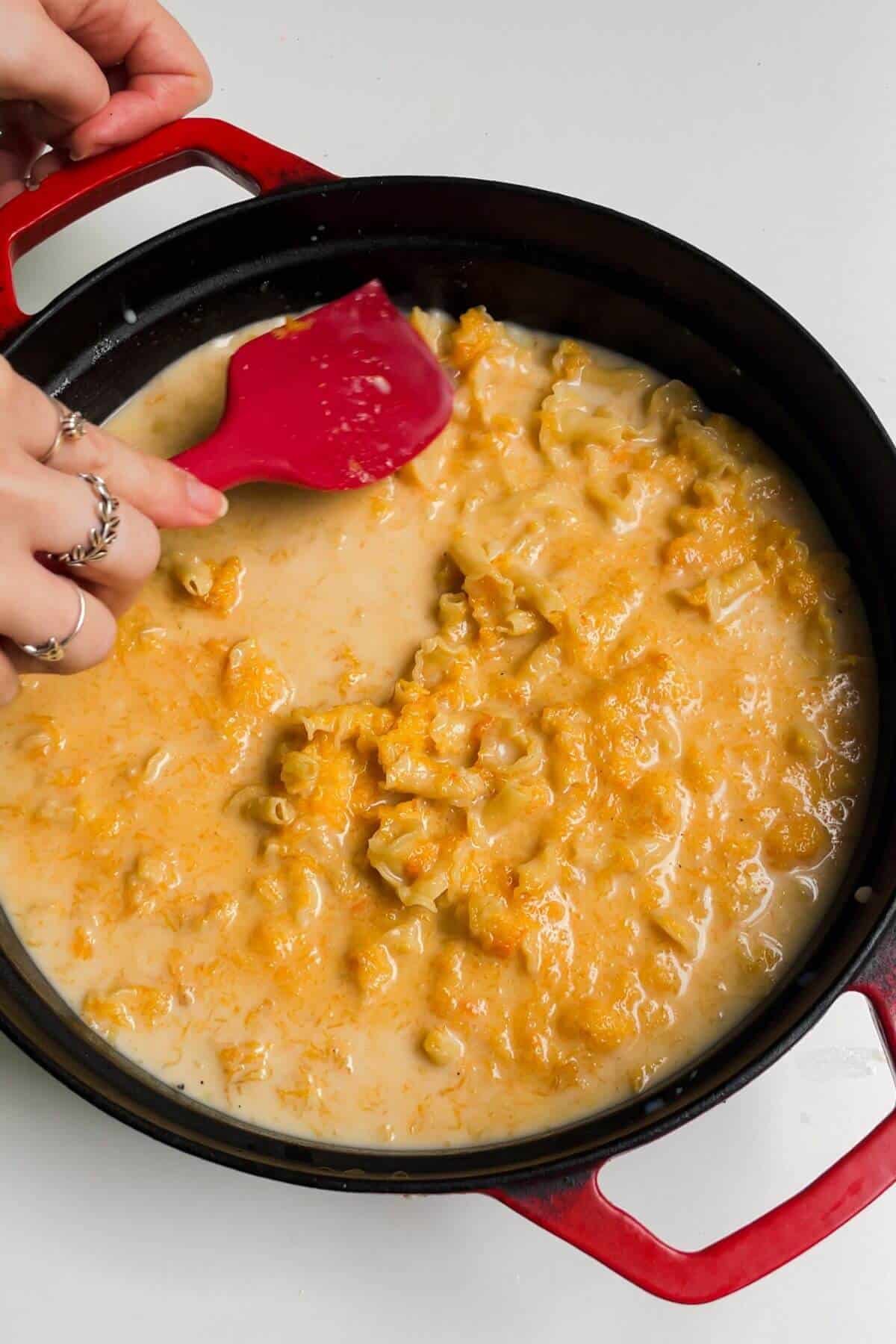 Stirring stock and milk through butternut squash mac and cheese.