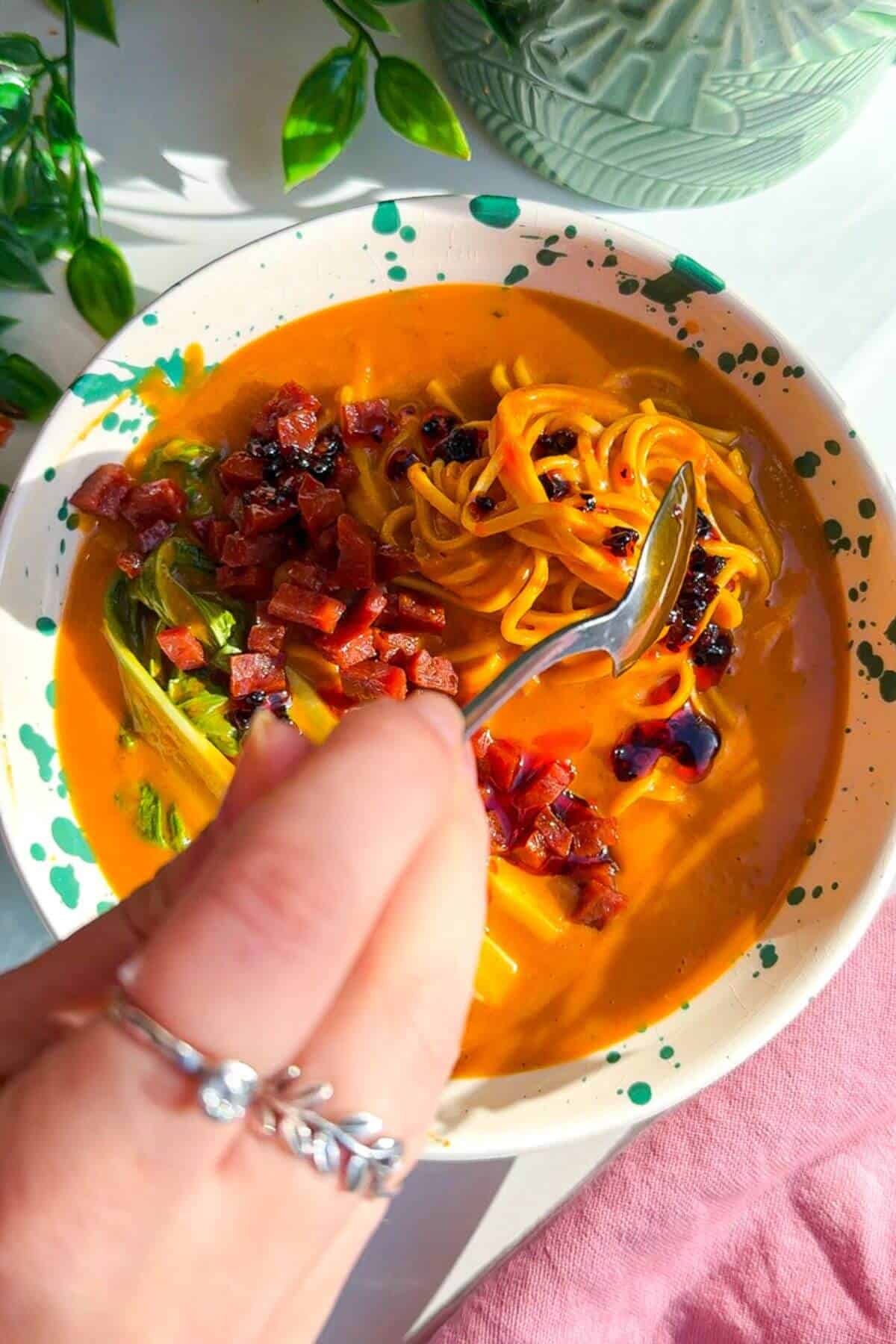 Topping butternut squash noodles with chorizo and chili crisp.