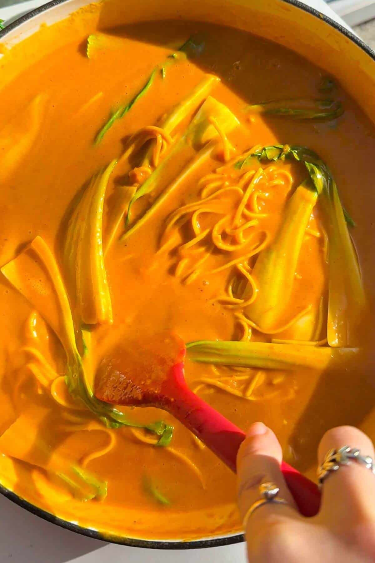 Stirring bok choi through butternut noodles.