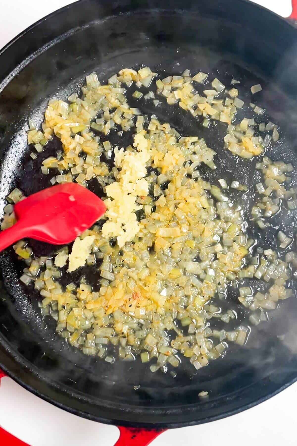 Cooking onion and garlic in a pan.