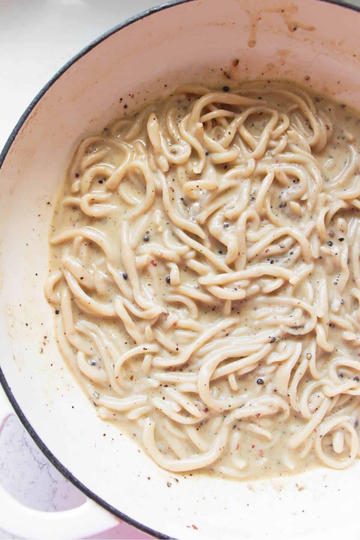 Cheesy, silky cacio e pepe in a pan.