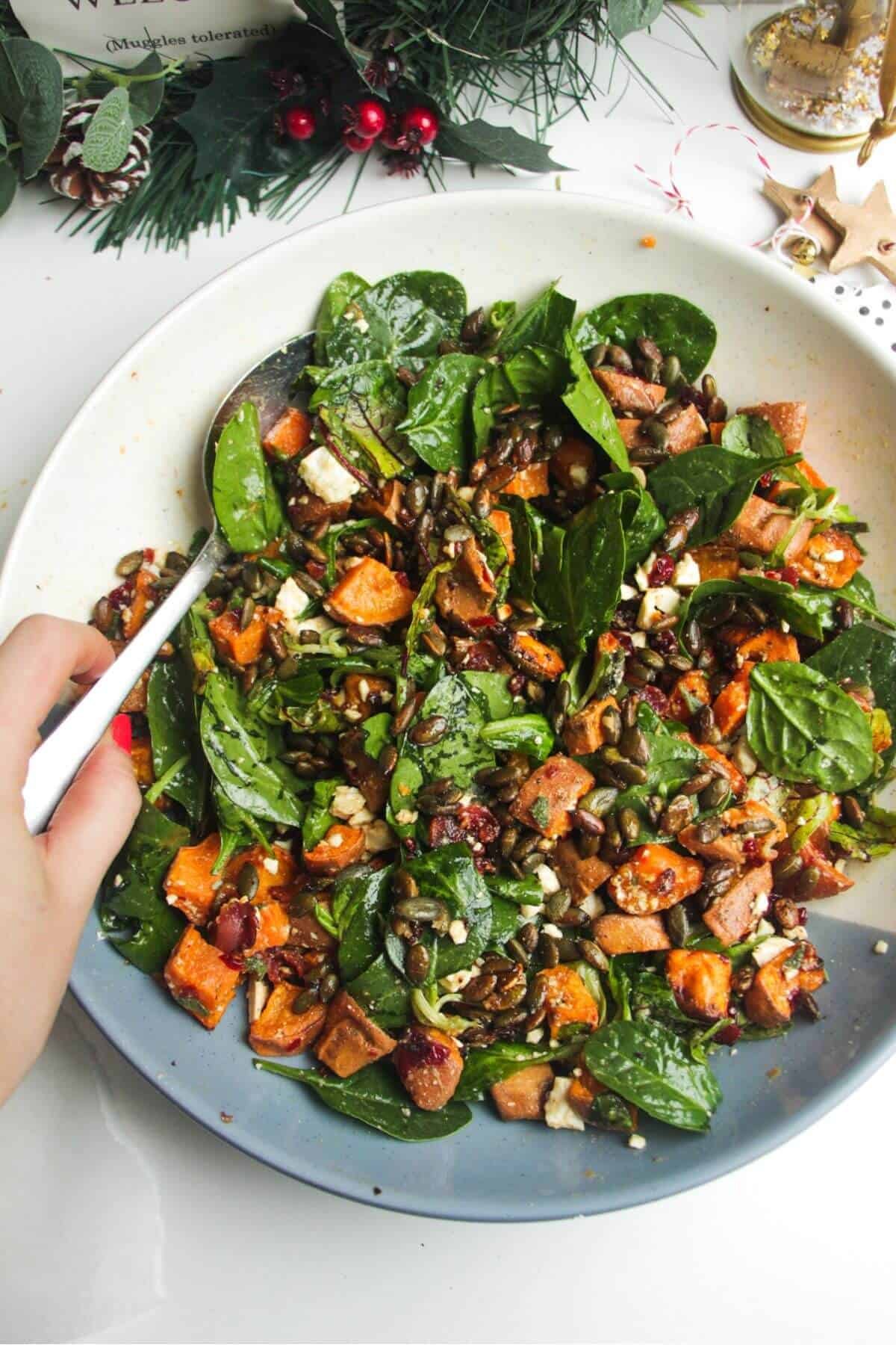 Roasted sweet potato salad in a large white and blue bowl.
