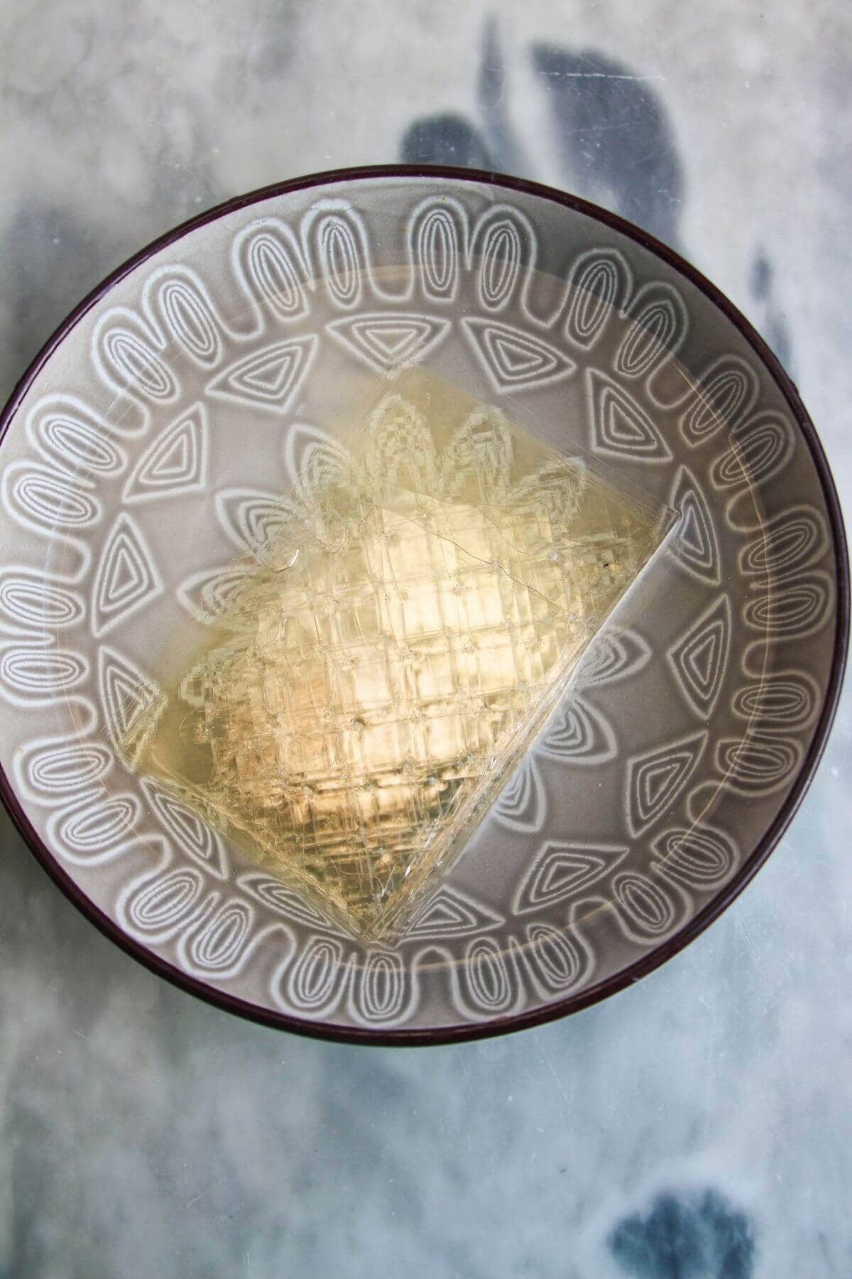 Gelatin sheets in a bowl of water.