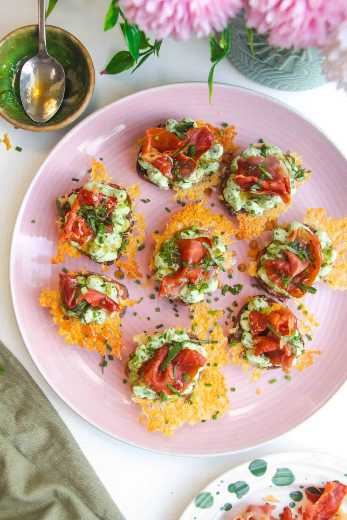 Herby ricotta cheesy crostini on a serving platter.