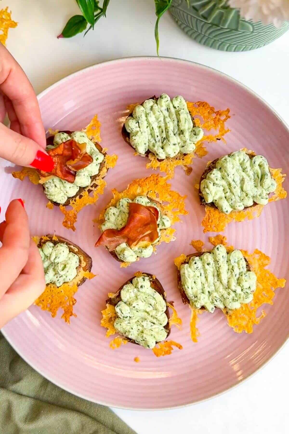 Topping ricotta crostini with crispy prosciutto.