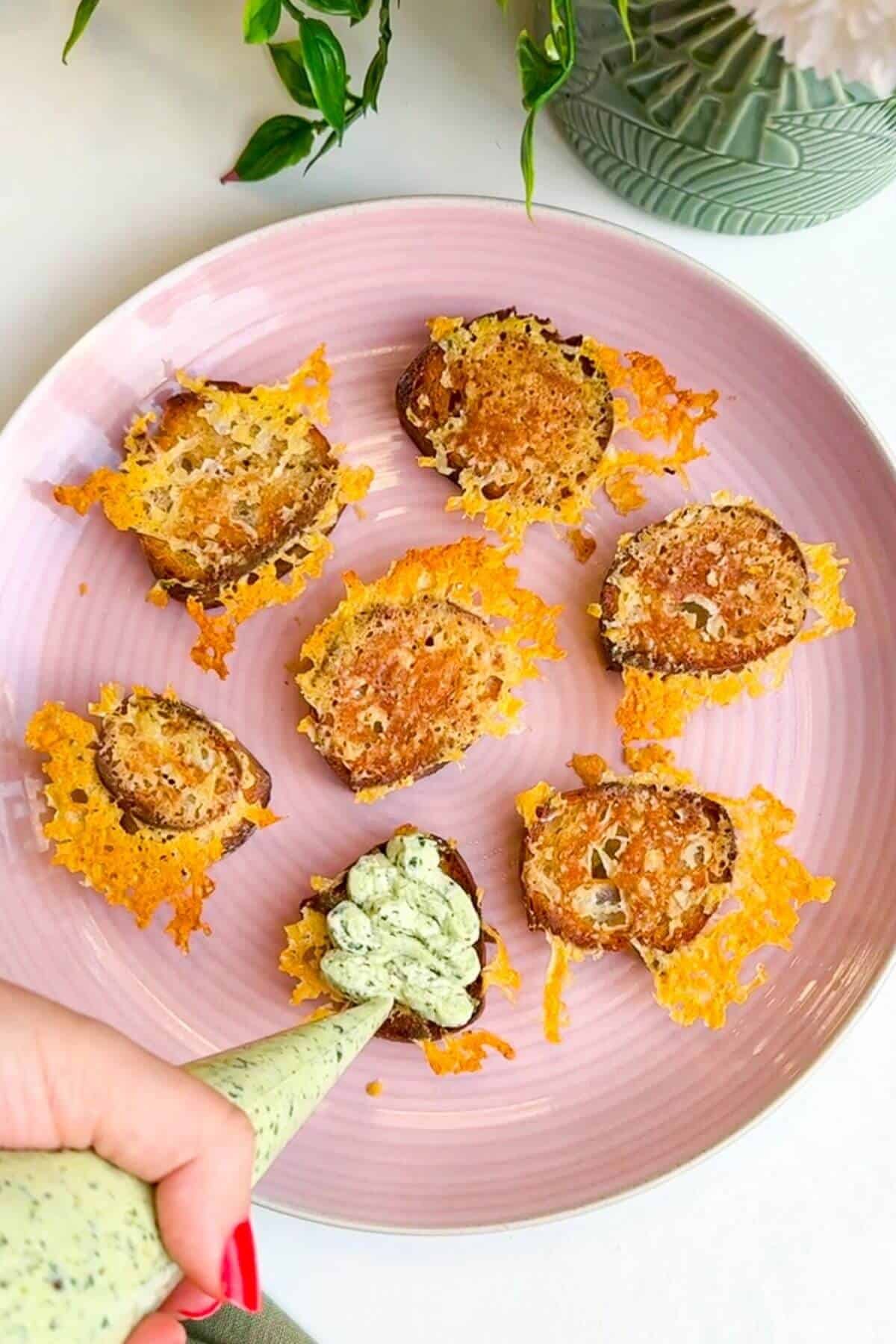 Topping cheesy crostini with herby ricotta.