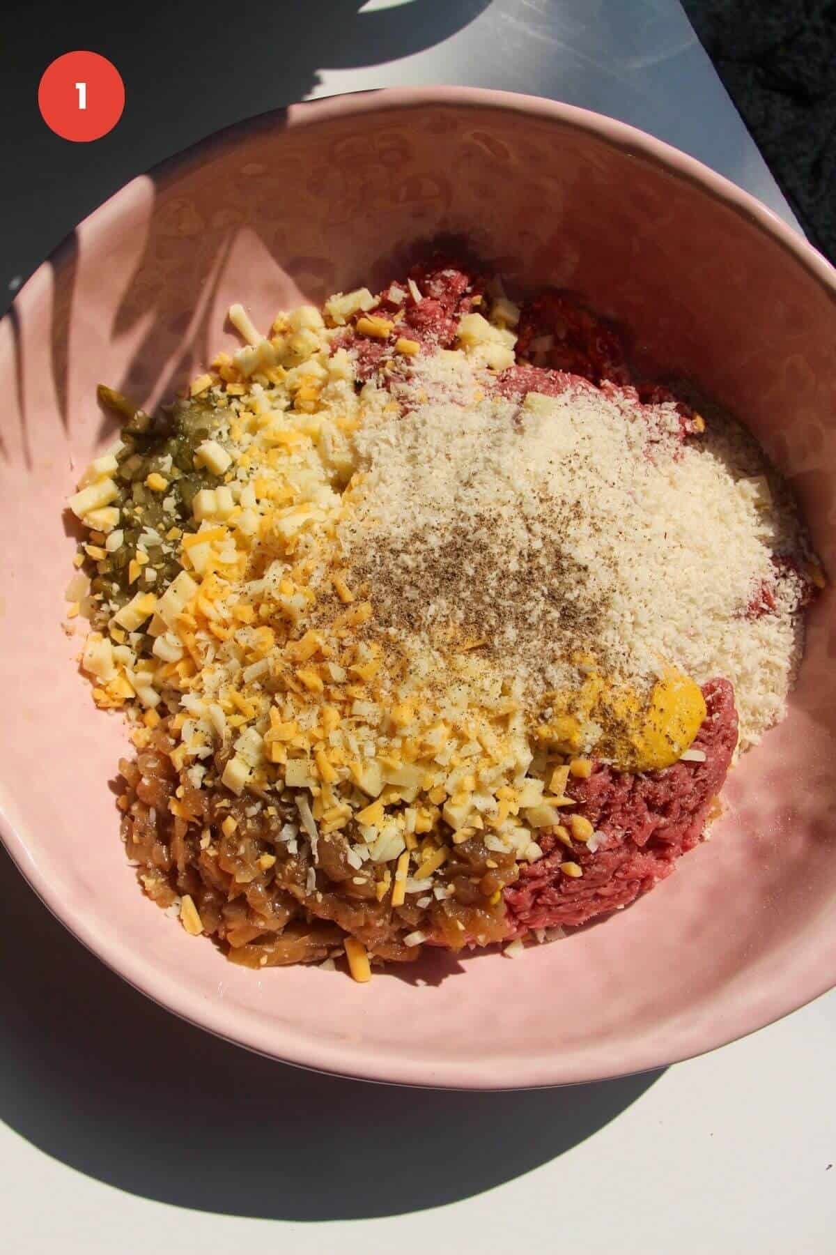 Cheeseburger meatball ingredients in large mixing bowl.