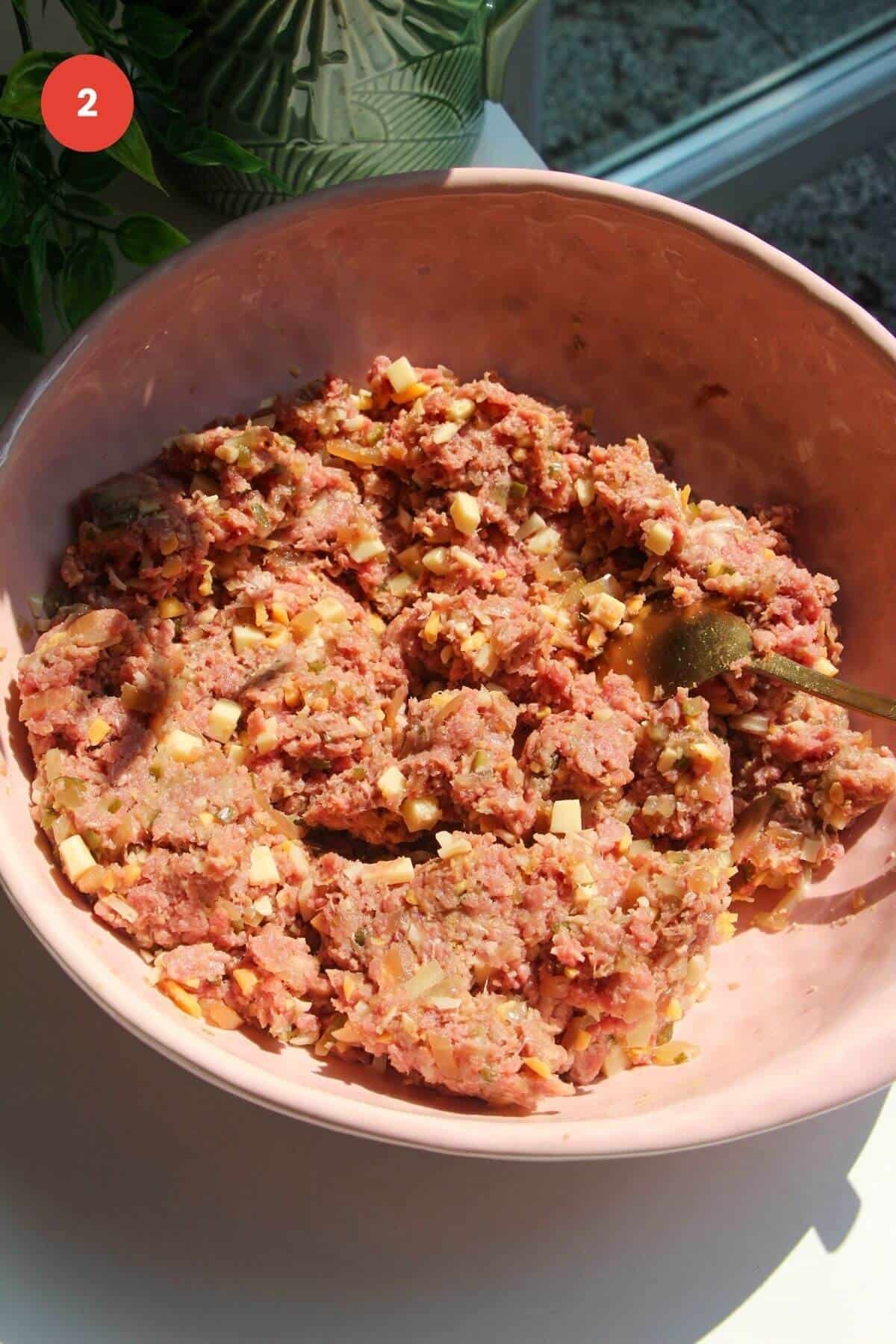 Cheeseburger meatball mixture combined in a large mixing bowl.
