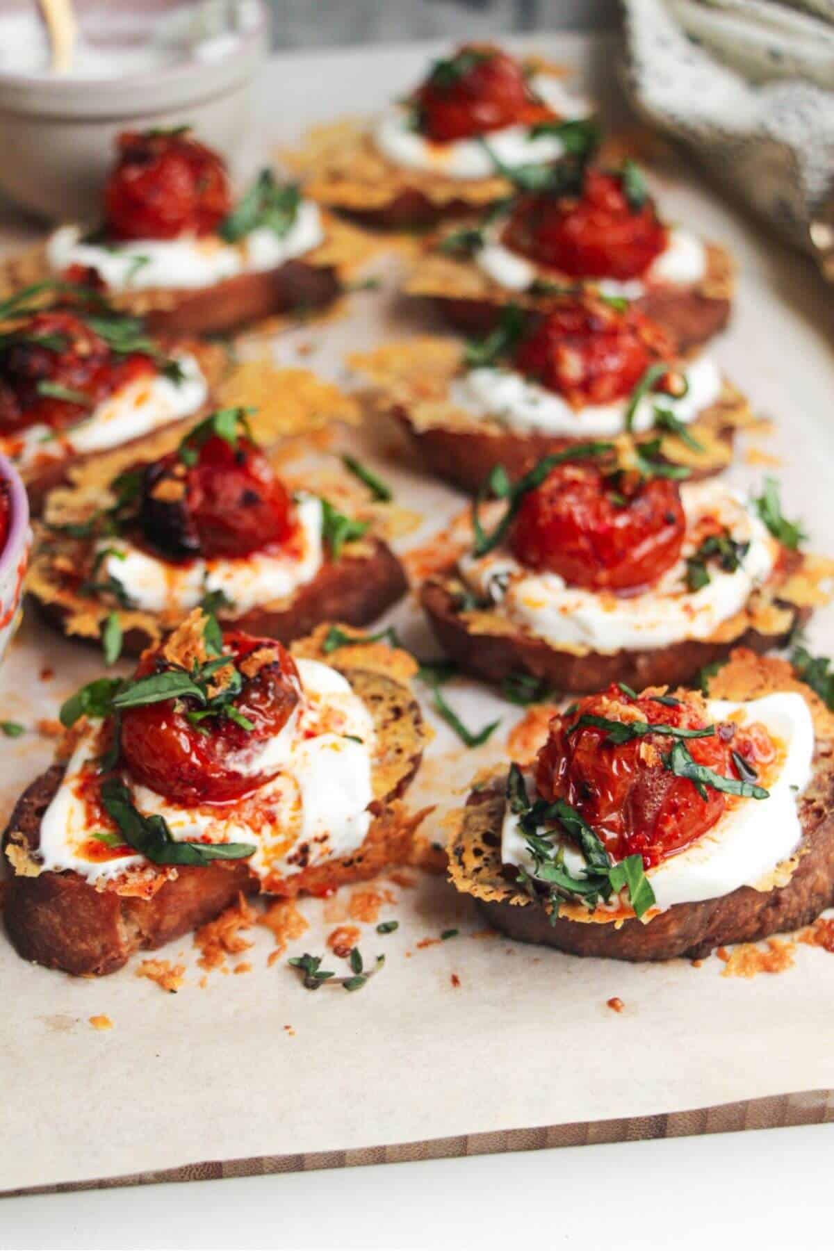 Close up of cheesy crusted roasted tomato crostini.