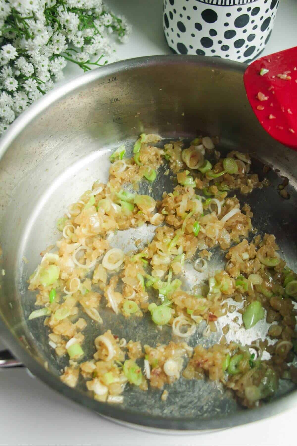 Onion, garlic and ginger cooking in a large pan.
