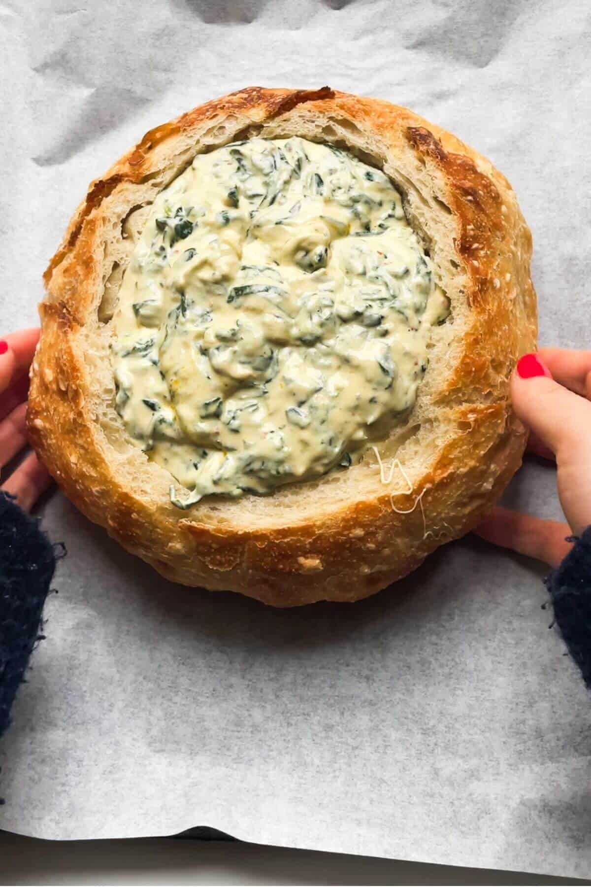 Creamy spinach dip in a bread bowl.