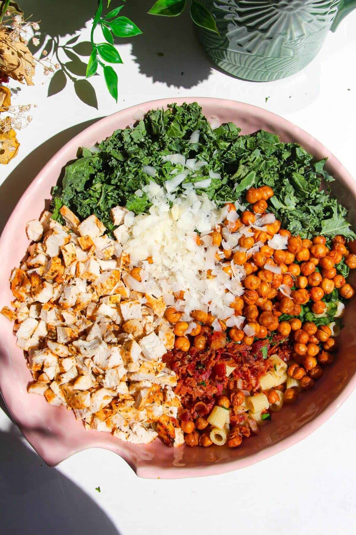 Caesar pasta salad ingredients in large mixing bowl.