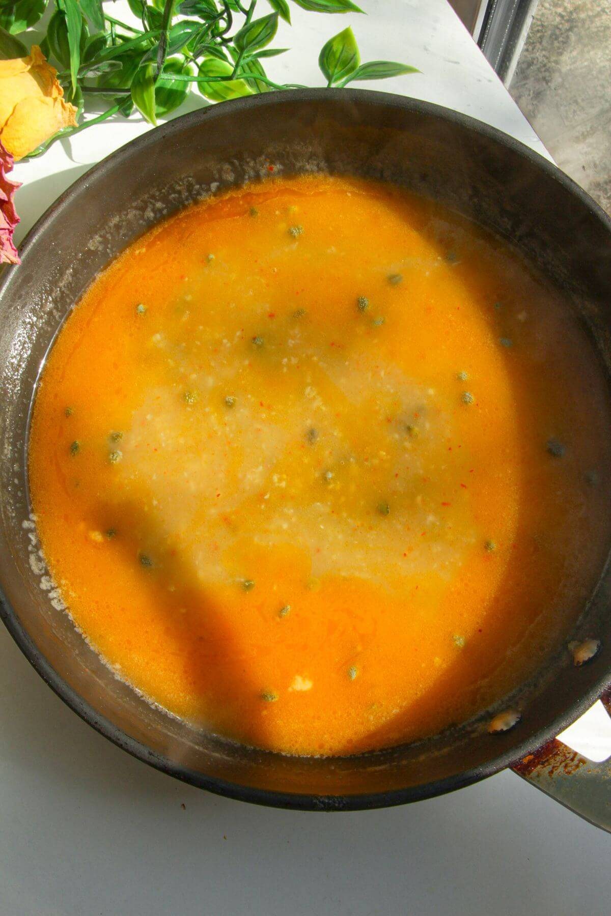 Lemon butter piccata sauce in a pan.