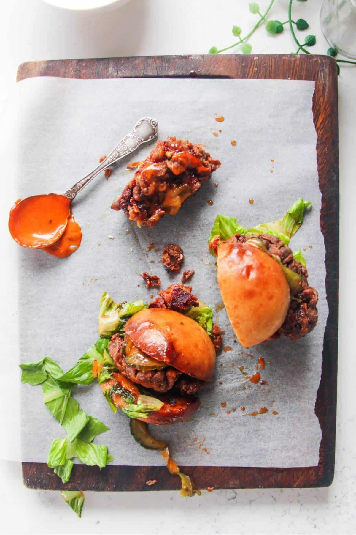 Fried chicken sandwich cut in half, with another piece of fried chicken on the side.