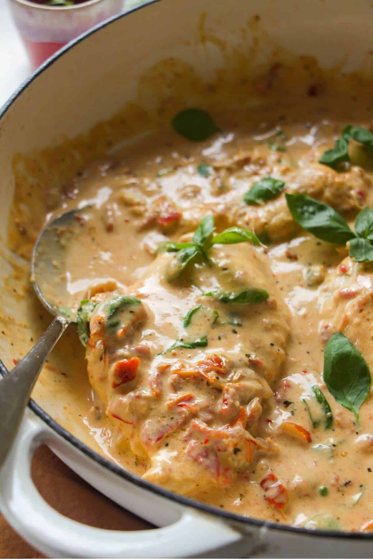 Close up of chicken breasts in creamy sundried tomato sauce.