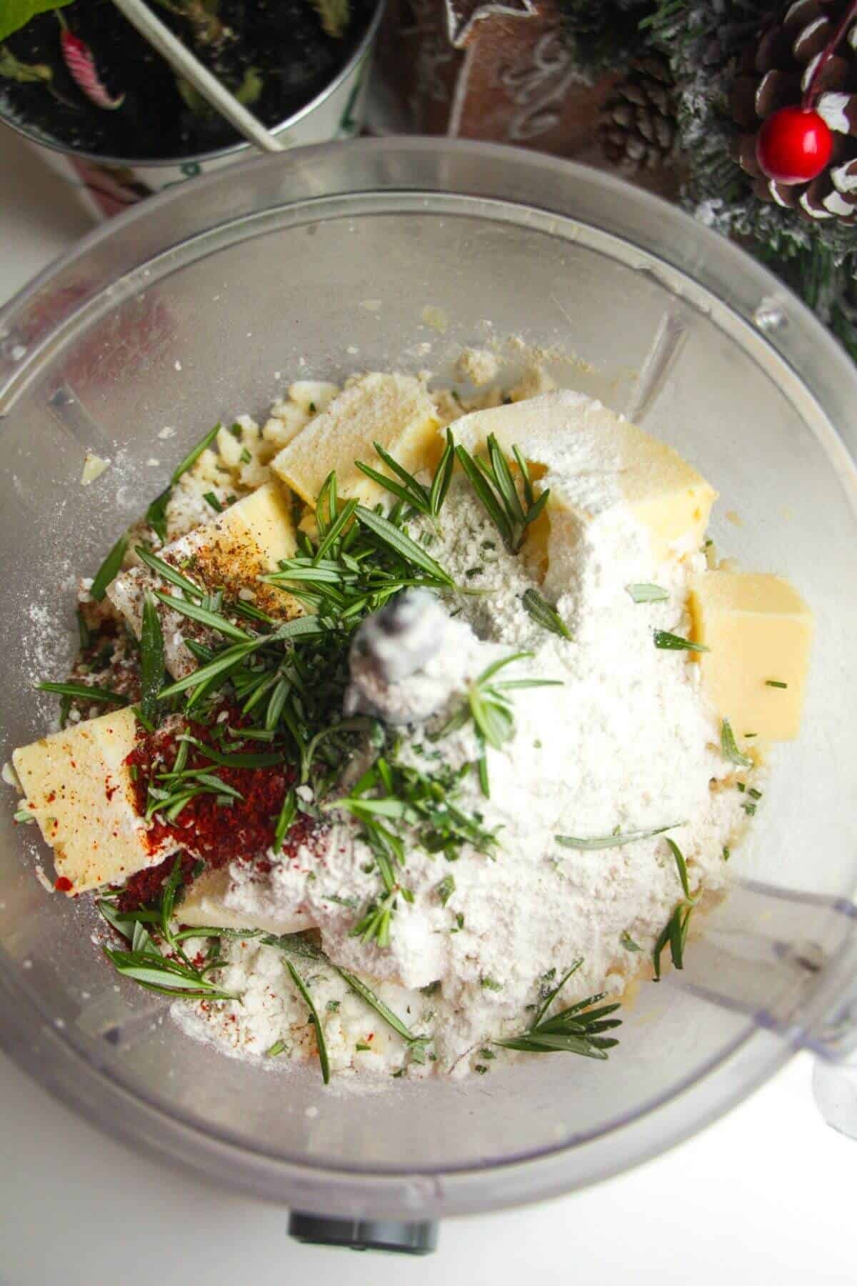 Flour, butter and herbs in food processor bowl.