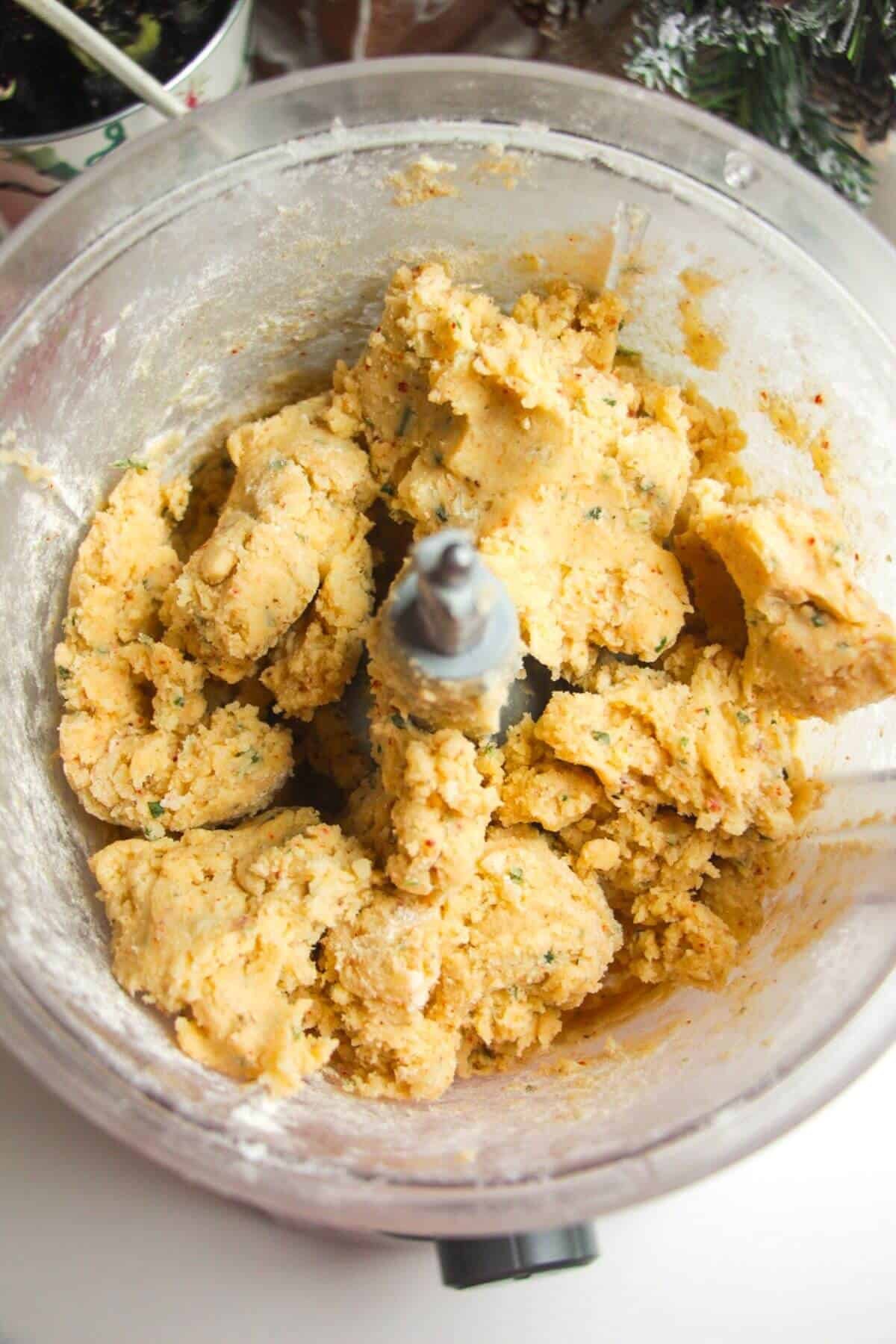Cheese shortbread dough in a food processor.