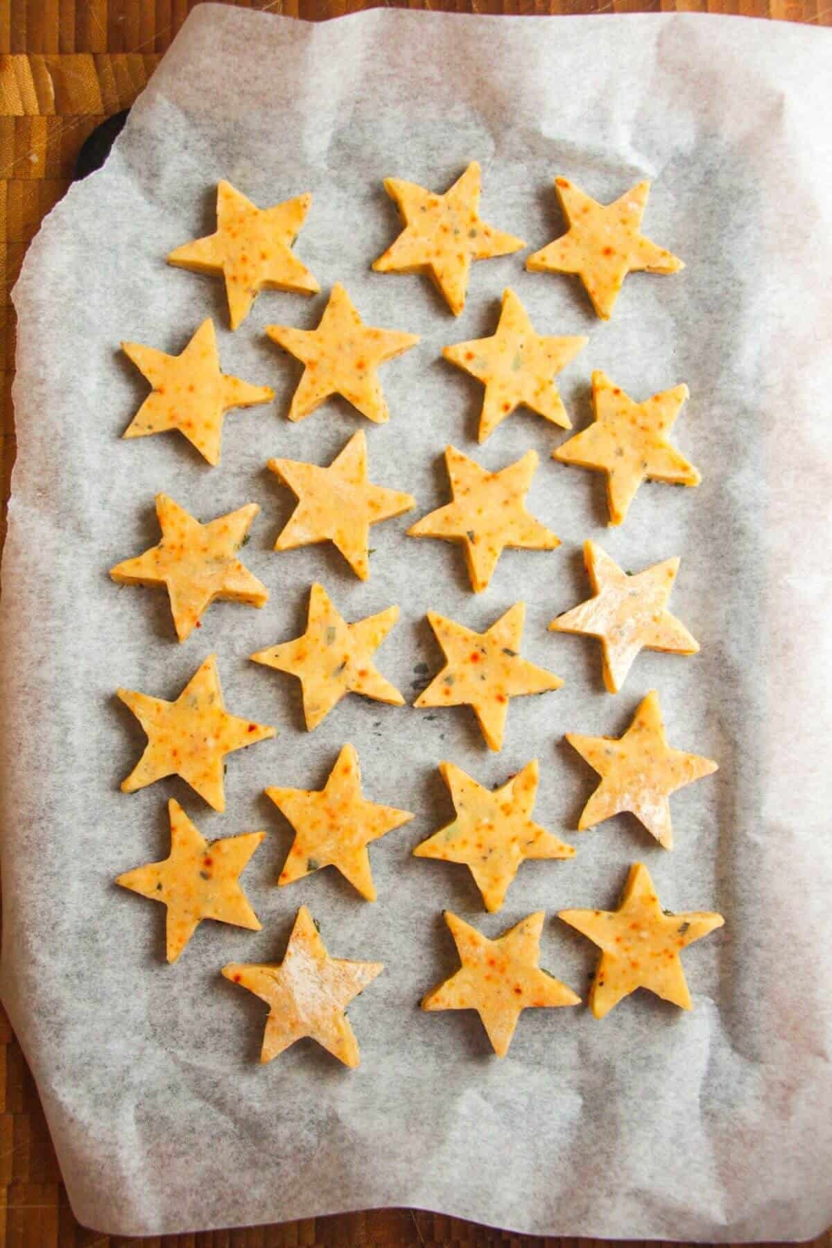 Shortbread stars on lined oven tray.