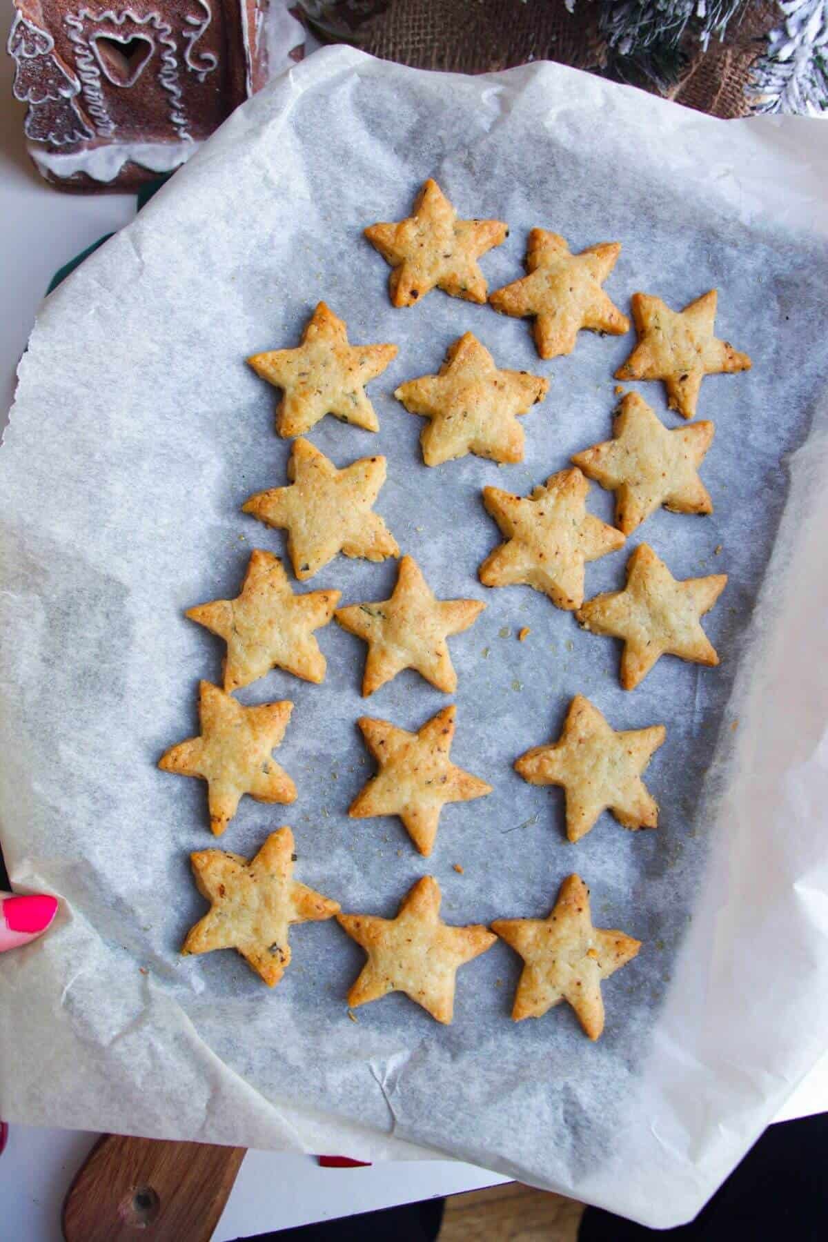 Baked chili cheese shortbread stars on a baking pan.