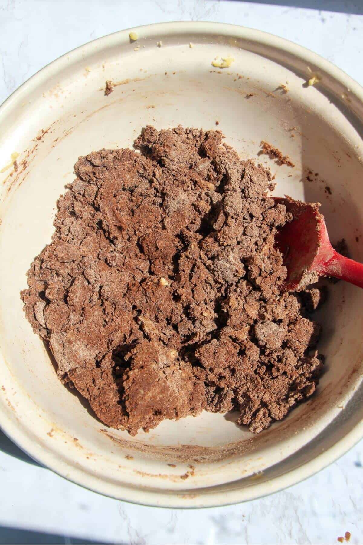 Afghan biscuit dough mixed in a large white mixing bowl.