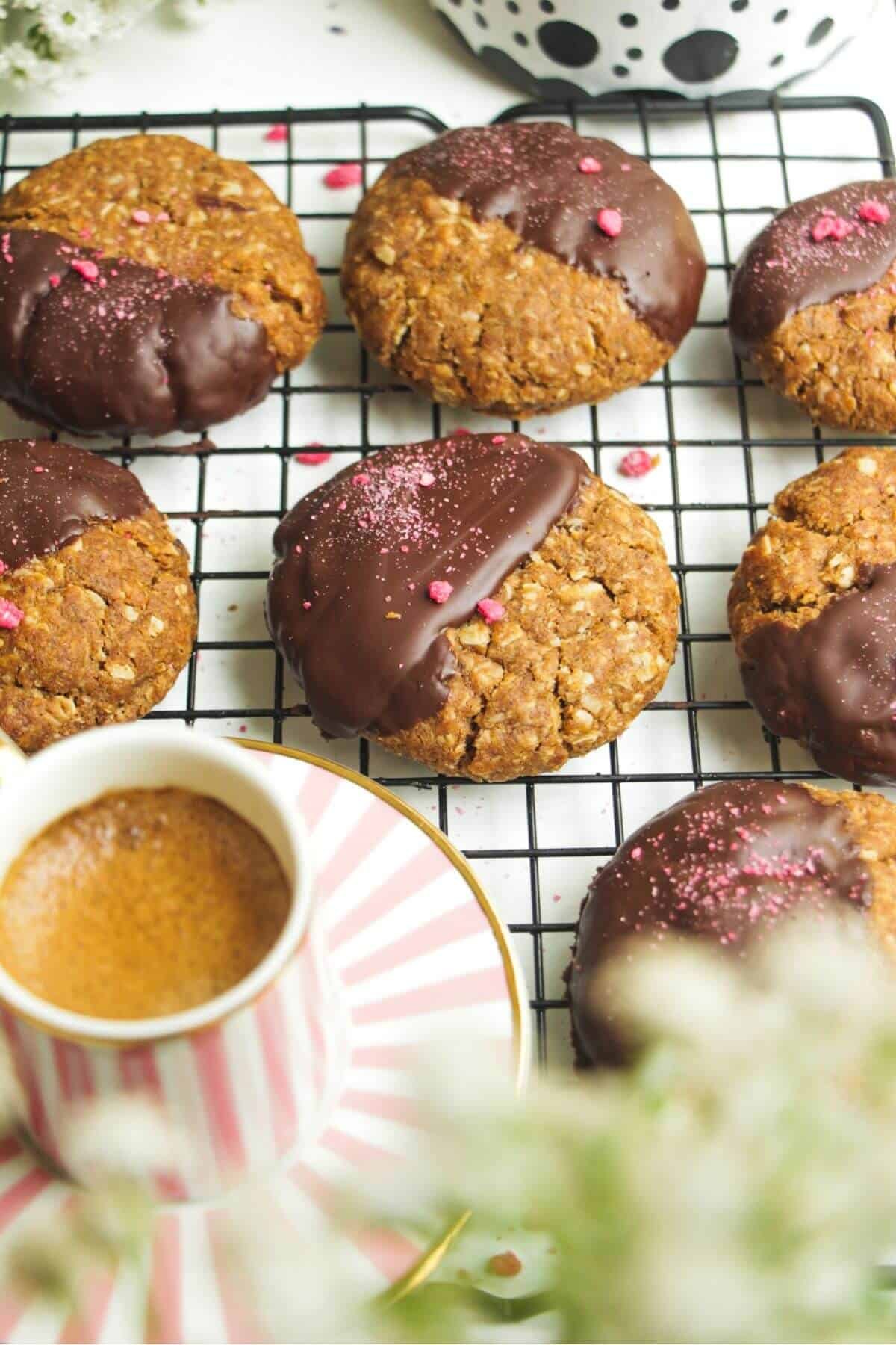 Chocolate dipped Anzac biscuits with coffee on the side.