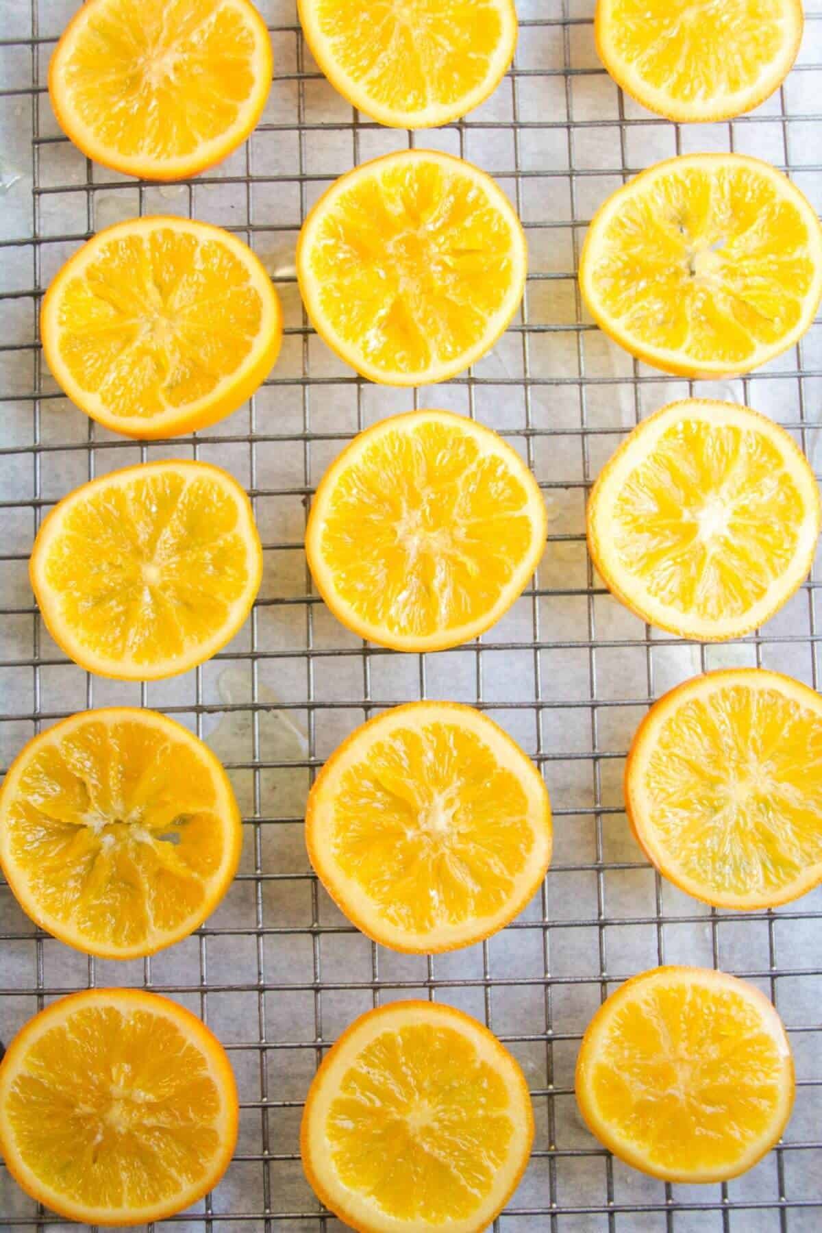 Candied orange slices laid out on a wire rack.
